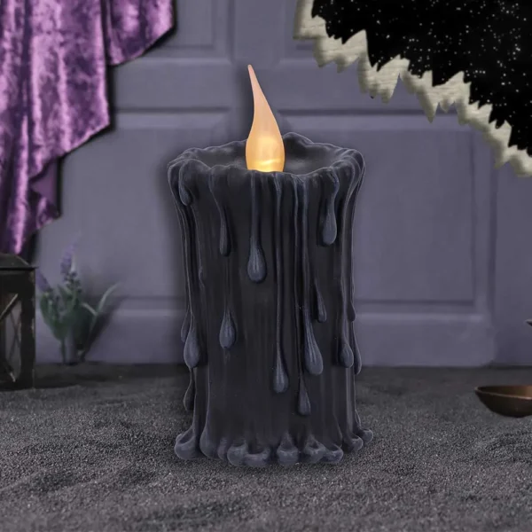 Black Wax LED Candle Gothic Decor - Purple Velvet Glow Black gothic LED candle with melting wax and warm flame beside purple velvet and starry backdrop.