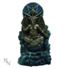 A bronze statue of Baphomet seated with wings, goat head, and raised hand gestures.