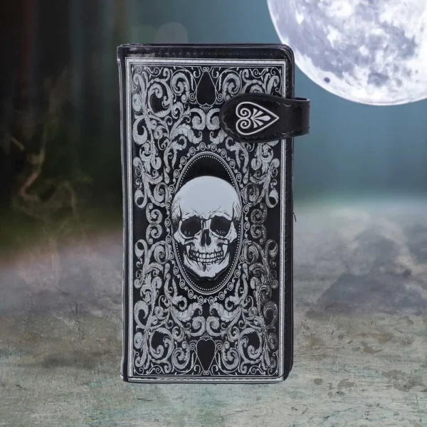 Gothic Leather Journal Black - Silver Skull Design Under Moonlight A black gothic leather journal with silver skull design under moonlight on textured ground.