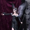 Gothic angel figurine with black gown, silver wings, and raven perched on her arm.