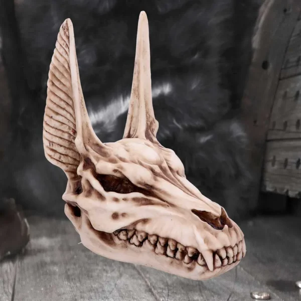 Demonic Skull Sculpture Ivory Bone Finish - Long Horn Ears A sculpted demonic skull with long horn-like ears and sharp teeth on a dark background.