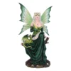 A silver-haired fairy figurine in a green gown holding a quill with a small green dragon.