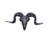 A black ram skull sculpture with ornate silver engravings and large curling horns.