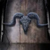 Metal Ram Skull Sculpture Silver Engraved Horns Rustic Wood A metallic ram skull sculpture with engraved horns mounted on aged rustic wooden background.