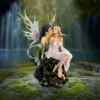 Fantasy Fairy Sculpture Resin Art - Dragon and Human Harmony Officially Licensed Merchandise Kiss Of Fate: Two fantasy female figures seated on mossy rock near waterfall, one dragon-like and one human.