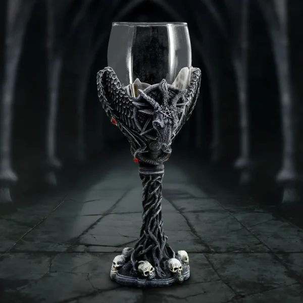 Gothic Goblet Glass Chalice Black With Goat Head And Skulls A gothic black goblet with goat head, wings, red gems, and skull base in dim light.