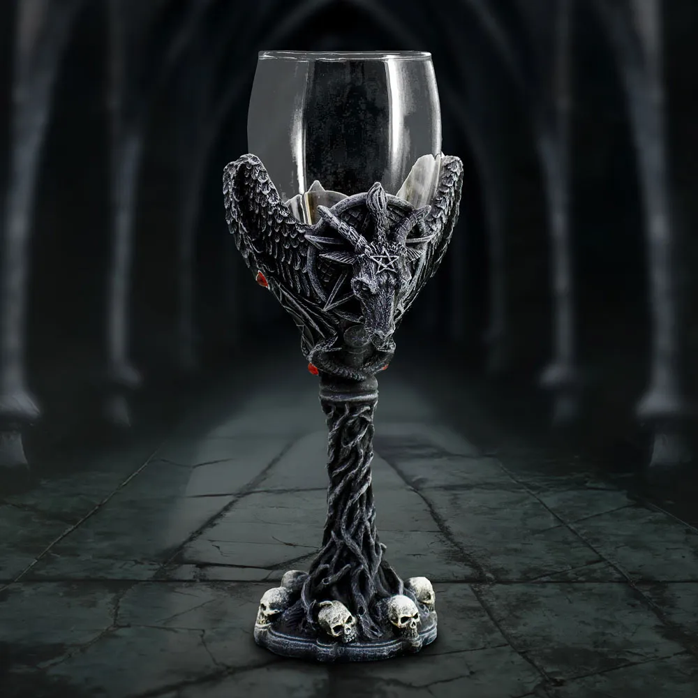 What Are Gothic Home Accessories? A Stylish Guide 3 A gothic black goblet with goat head, wings, red gems, and skull base in dim light.