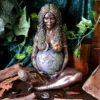 Bronze Gaia statue of pregnant Mother Earth with globe belly, sun, moon, and nature details.