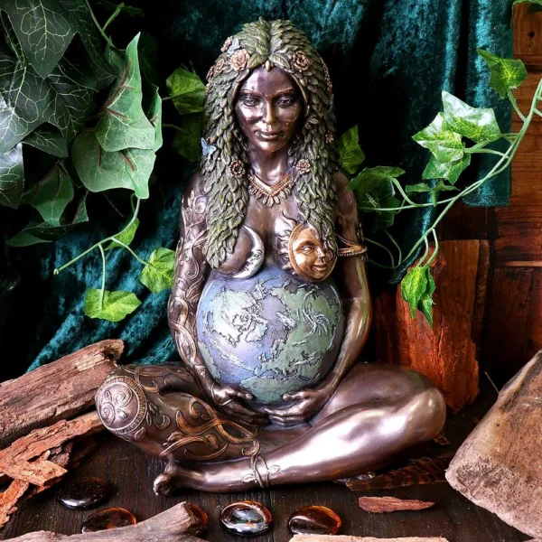 Bronze Gaia statue of pregnant Mother Earth with globe belly, sun, moon, and nature details.