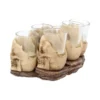 Skull Shot Glass Set Resin Holders Beige - Gothic Bar Decor Four decorative skull shot glasses on a rustic brown base with clear removable glass cups.