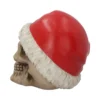 Human Skull Resin Sculpture Red Santa Hat - Gothic Christmas Decor A beige human skull wearing a red Santa hat on a white background. The-Hidden-Hatch