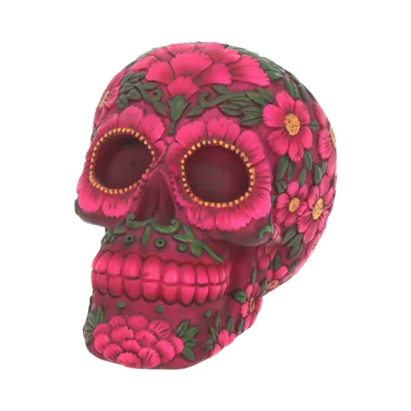 A pink floral sugar skull decorated with detailed soap flower petals and green leaves.