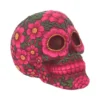 A pink floral Day of the Dead skull decorated with intricate soap flower designs.
