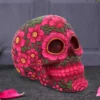 Mexican Calavera Skull Sculpture Pink Floral Design - Handcrafted A colorful floral-decorated Mexican skull sculpture with pink soap flowers and green leaves for Day of the Dead.