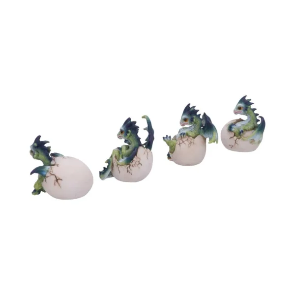 Four green baby dragon figurines hatching from cream-colored eggs in a fantasy-themed display.