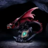 Black Red Dragon Statue Resin Sculpture - Glowing Crystal Base Collectable Home Accessories A black and red dragon statue guarding a glowing green-blue crystal in a dark cave.