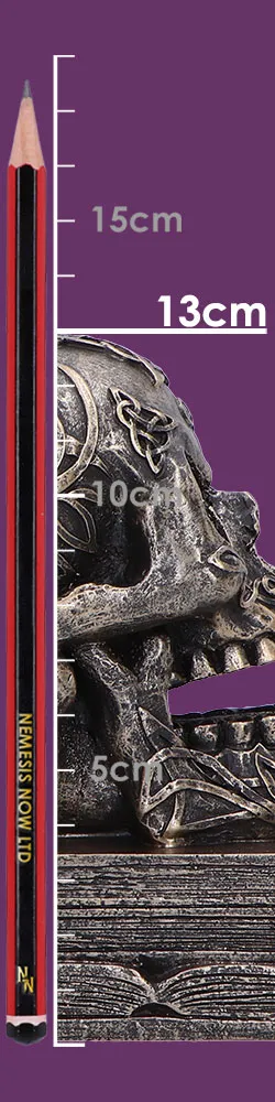 Celtic Skull Ornament Metallic Gray Sculpture - 13cm Decorative A Celtic skull ornament beside a red measuring pencil on a wooden surface. The-Hidden-Hatch